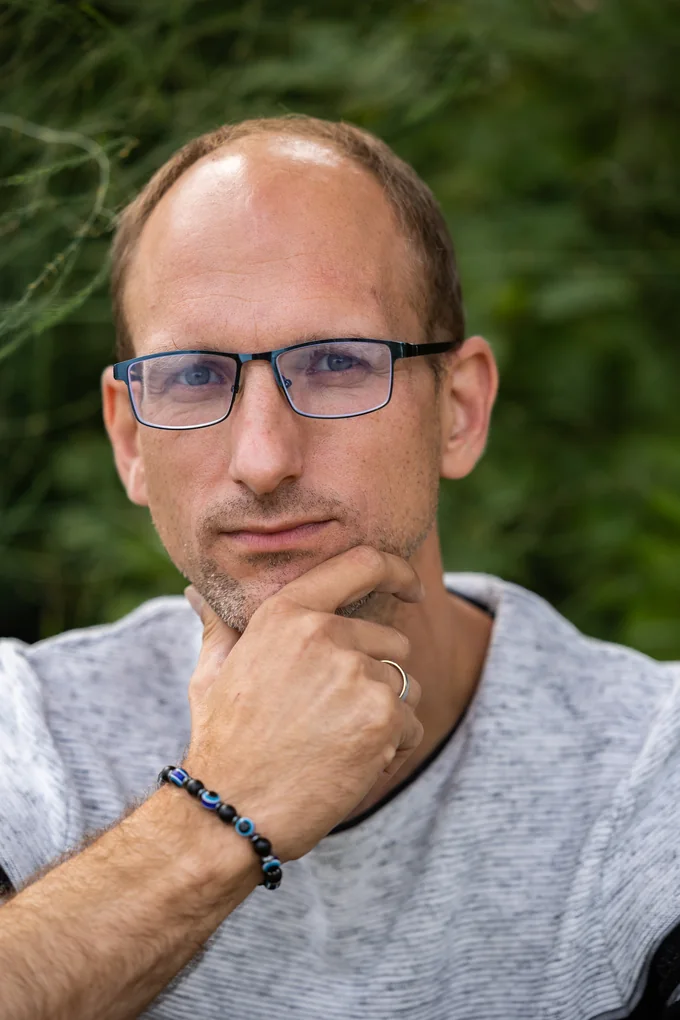 Close-up professional portrait of Aigars Kauliņš outdoors